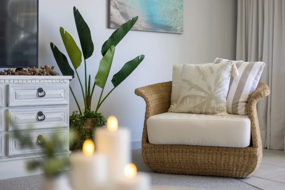 Woven armchair with cushions in an apartment lounge