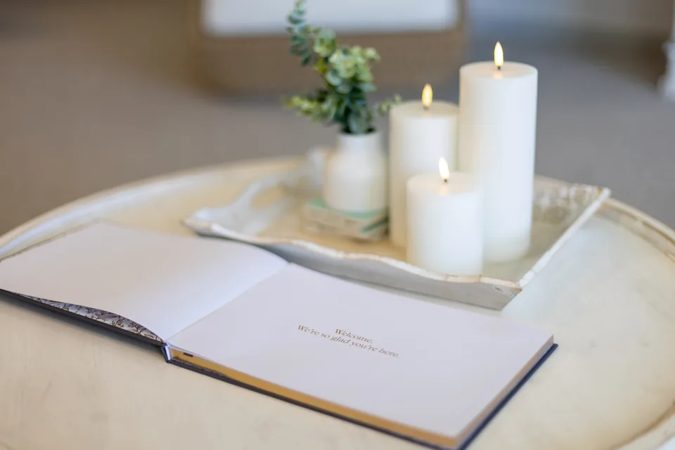 Candles and a welcome book on a side table